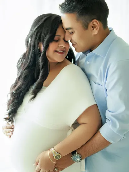 A sweet and loving embrace. This studio portrait is filled with warmth and tenderness, perfectly capturing the couple’s excitement.