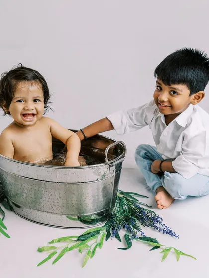 Another adorable moment between brothers during a first birthday splash session. The older brother is so proud and happy to be included.