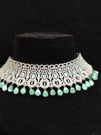 This silver-finish choker with mint green stones is a fresh and modern take on occasion wear. Rent it for a daytime event or a beach wedding.