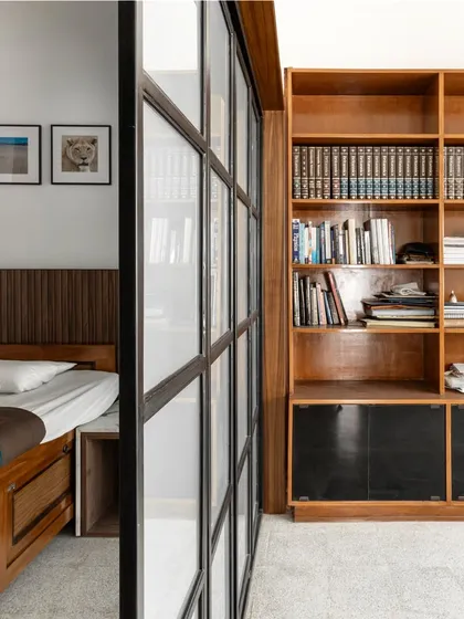 Renovation is about reimagining possibilities. By introducing a translucent sliding partition, we transformed a single large bedroom into three distinct zones: a sleeping nook, a study, and a wardrobe area. This solution provides privacy and function while maintaining a sense of openness and light.