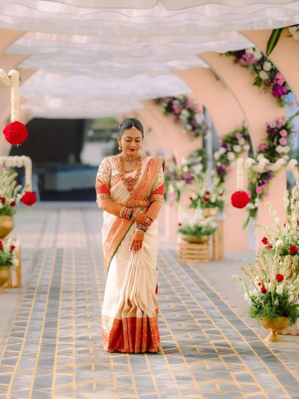 The bride's complete wedding look, showing how the custom blouse complements the flow and drape of her traditional silk saree.