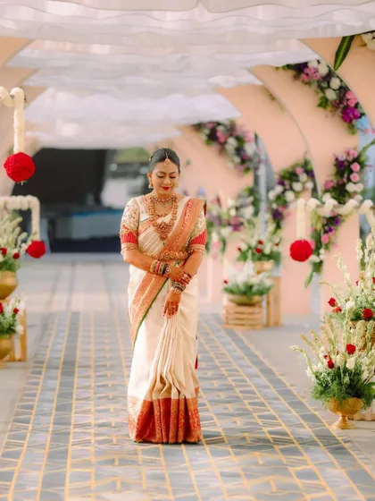 The bride's complete wedding look, showing how the custom blouse complements the flow and drape of her traditional silk saree.
