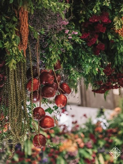 A close-up of the 'Orchard of Life' decor, with red apples hanging from the floral trees, symbolizing life and abundance.