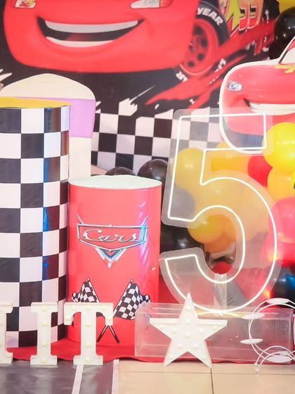 A vibrant 'Super Mario' themed birthday party, with character cutouts, a custom backdrop of the Mushroom Kingdom, and red and green balloons, ready for an adventure.