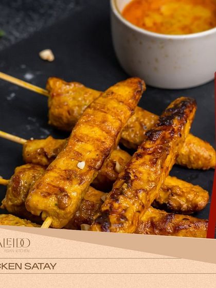 Juicy and tender Chicken Satay skewers, grilled to perfection. They are served with a rich and creamy peanut dipping sauce, a classic and beloved starter.