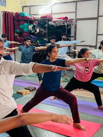 I lead the class in Warrior II, ensuring everyone's alignment is correct. This foundational pose builds strength and stamina for the entire practice.