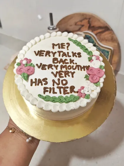 Sometimes you just need a cake that says it all. This custom cake features a funny, sassy quote piped on top, surrounded by a floral border.