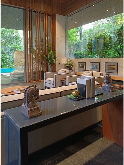 A view from the pantry-bar into the lounge, showing how carefully chosen artifacts like chess pieces and books are used to accentuate the space.