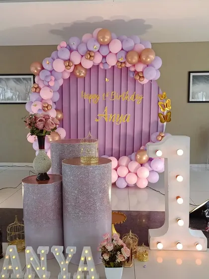 The complete setup for Anya's first birthday, including the backdrop, cake stands, and illuminated props.