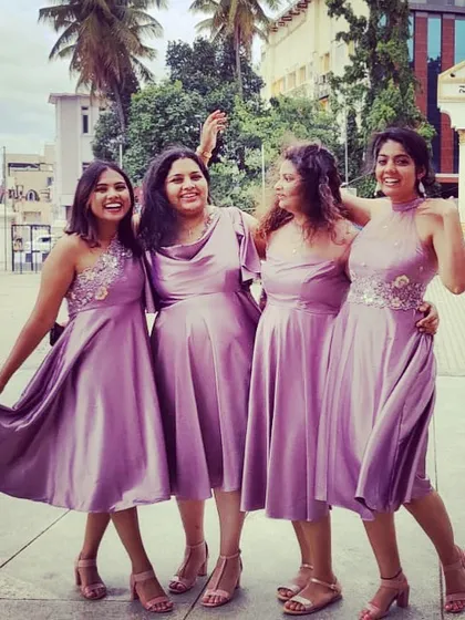 A happy bride tribe! We designed these coordinated lilac satin dresses for a wonderful group of bridesmaids.