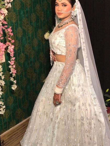 A full-length view of the white sequined lehenga, showing its sparkle and flow.