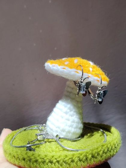 A yellow version of the mushroom jewelry holder, showing its versatility with different colors.