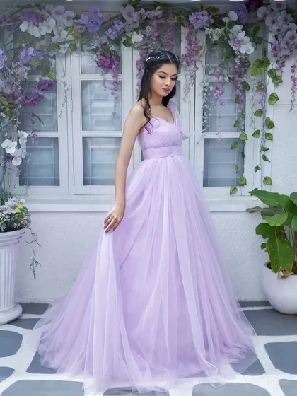 A full-length view of the 'Gorgina' gown. The simple, flowing tulle skirt perfectly balances the intricate, hand-embroidered 3D leaves on the bodice.