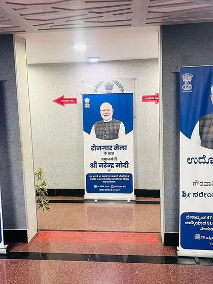 Directional standees and signage inside the venue for the Rozgar Mela. Clear navigation and crowd management are key components of our event infrastructure services.