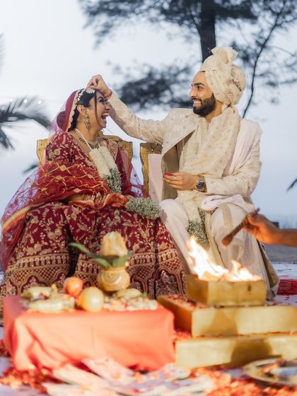 A playful moment during the wedding rituals by the sacred fire. We believe that even the most traditional ceremonies are filled with moments of fun and personality.