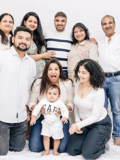 The whole 'khandaan' together for a first birthday. Getting everyone in one frame, full of smiles and playful energy, creates a cherished portrait of the entire family.