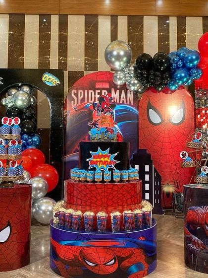 A full view of the impressive Spider-Man dessert station, complete with themed plinths, character cutouts, and comic book-style art.