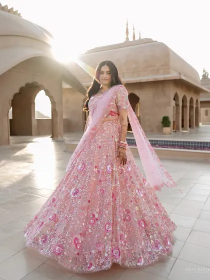 Bathed in the golden hour light of Jaipur, Brinda is a vision in her custom pastel lehenga. My creative direction for this shot was to capture the sheer joy and fairytale quality of her look against the sun-kissed architecture of the Fairmont.