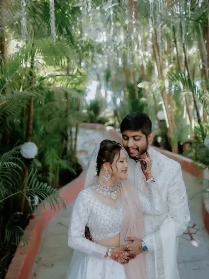 A picture of pure happiness. This beautiful couple moment shows how the right jewellery can elevate the entire wedding look. The bride's delicate zircon set adds a touch of sparkle to her elegant white lehenga.