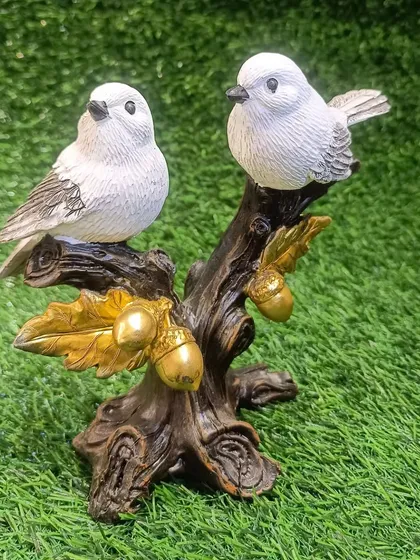 Another angle of the bird couple, showing the delicate details of the feathers and the golden acorns.