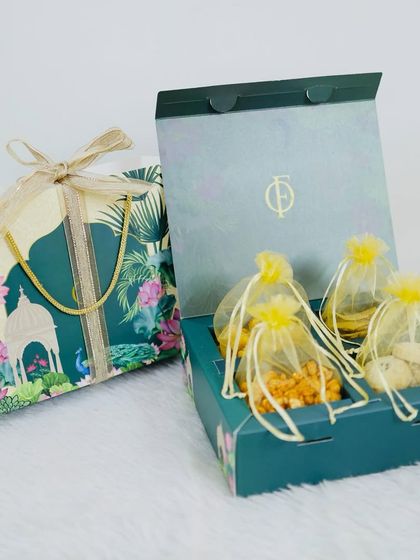 Our premium Diwali gift box is designed to impress. Featuring a beautiful floral motif, it opens to reveal four pouches of our finest handmade snacks and sweets, making it an elegant choice for festive gifting.