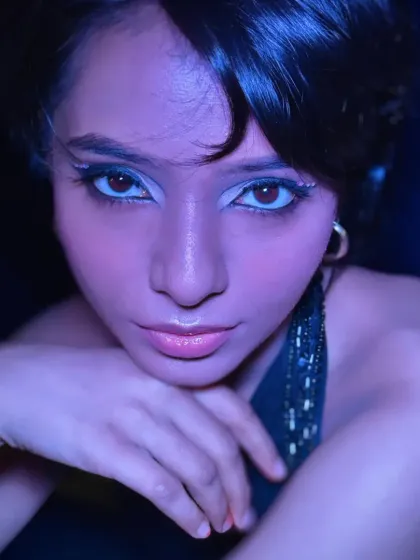 The same makeup look under cool, blue lighting, demonstrating its versatility and how it transforms in different lighting conditions, a key consideration for shoots.