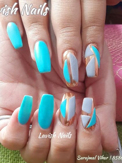 A bold, abstract geometric design using turquoise, grey, and gold chrome on long coffin nails.