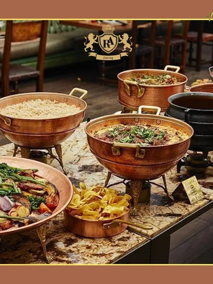 My signature buffet setup brings a touch of grandeur to any occasion. I use elegant copper and brass chafing dishes to keep main courses like biryani and curries perfectly warm, creating a dining experience that feels both luxurious and inviting.
