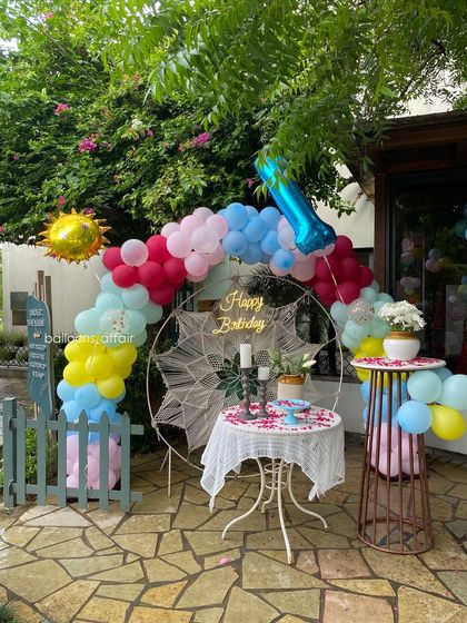 Another view of the cafe birthday decoration, showing the full setup with the cake tables.