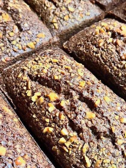 A close-up of my nut-topped mini chocolate loaf cakes, fresh out of the oven. The texture is dense and moist, and the nuts add a perfect crunch.