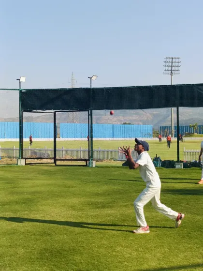A player demonstrates the "soft hands" technique for catching, a key detail we focus on in our fielding coaching.