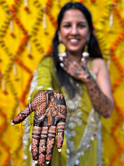 A stunning close up of a bride's palm, featuring a portrait of a traditional Indian woman. The focus and detail in this shot are incredible.
