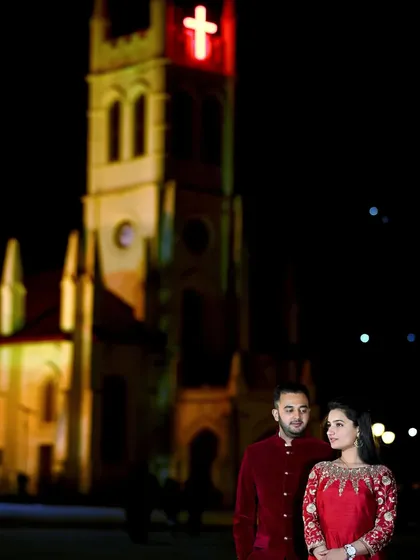 A beautiful night-time pre-wedding photo in Shimla, with the iconic Christ Church illuminated in the background. Night shoots offer a different kind of romance and drama.