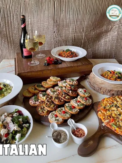 A full Italian feast from our menu. This image displays a variety of our offerings, including pizza, pasta, bruschetta, and salad, perfect for a house party.