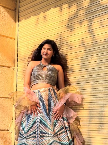 The halter-neck sequin blouse adds a touch of glamour to this trendy lehenga set.