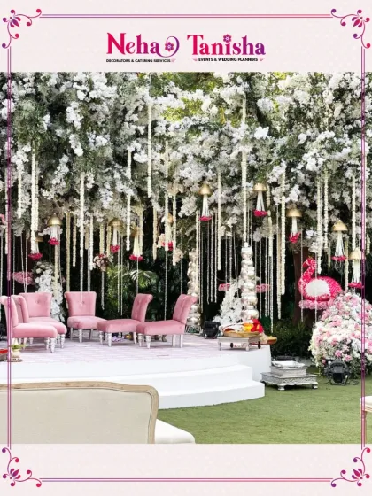 Crafted just for you, this stunning pink and white decor transforms any space into a magical setting. The lush canopy of white blossoms and hanging florals creates a dreamy backdrop for an elegant outdoor event.