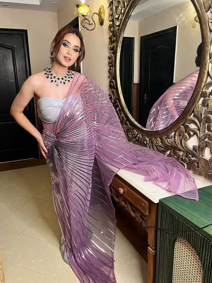 A full-length shot of this stunning, high-fashion look. The makeup is bold and glamorous, perfect for a reception or cocktail event.