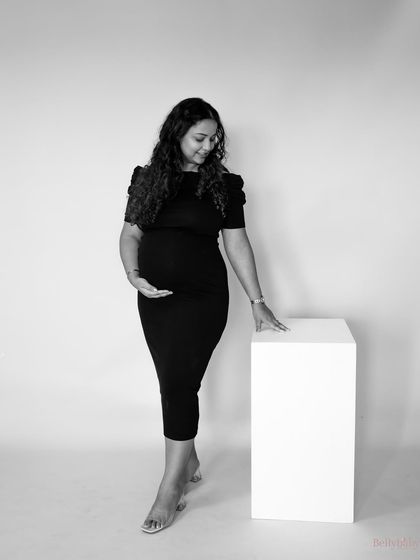 A simple, standing black and white portrait that feels both strong and gentle. It's a beautiful way to remember the feeling of carrying your baby.