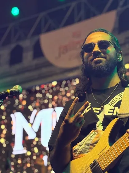 Our guitarist giving the peace sign to the crowd, enjoying the vibe at the Ernst & Young show in Pune.