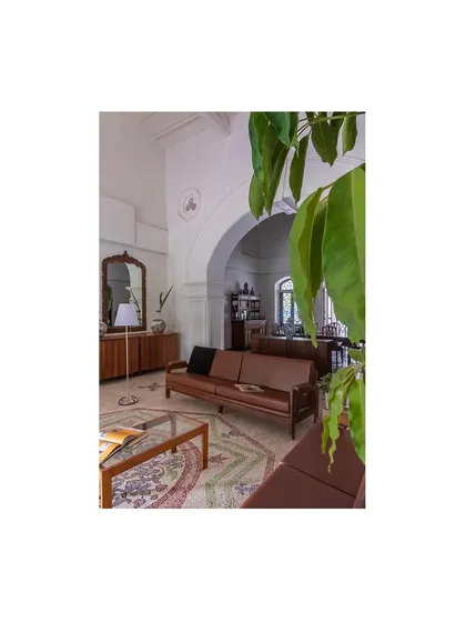A quiet corner in the living area, where restored antique furniture sits atop the original mosaic floor. We seamlessly integrated modern comforts while maintaining the historical integrity of the space.