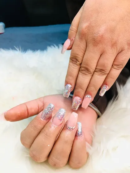 A beautiful set of coffin-shaped extensions with a mix of nude pink, silver glitter, and delicate rhinestone accents.