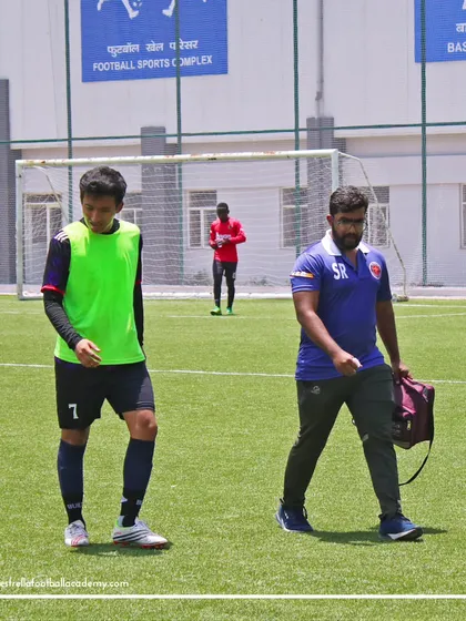 My on-field physio walks with a player, ensuring everyone stays fit and gets immediate attention for any strains or injuries during the demanding trial process.