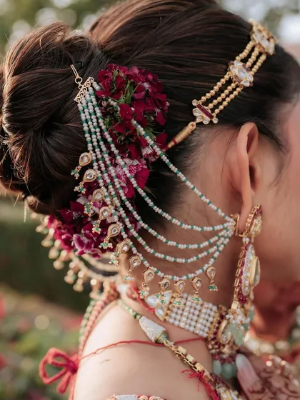 A look is never complete without the perfect hairstyle. My workshops include sessions from my expert team on professional hairstyling, where you learn to create beautiful, intricate updos like this one, adorned with fresh flowers and traditional accessories.