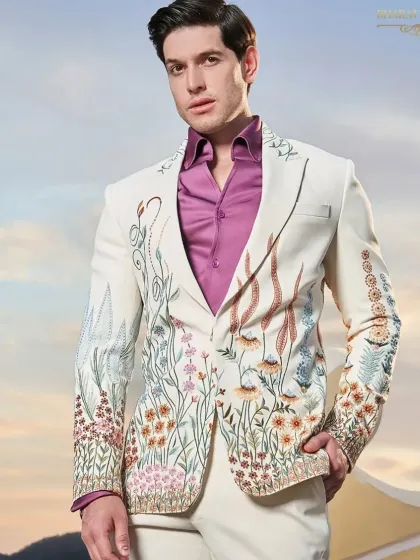 A fresh take on the formal tuxedo, this ivory jacket is adorned with vibrant, multi-colored floral embroidery. It's a perfect example of how I blend traditional craftsmanship with contemporary design for a standout cocktail or sangeet outfit.