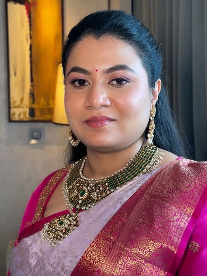 A portrait showing the final traditional look. The makeup is perfectly balanced to enhance her features while looking natural and feeling comfortable under the lights.
