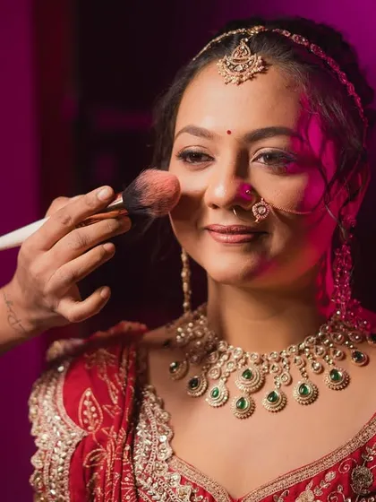 A glimpse behind the scenes. Here I am adding the final touches of blush to give that perfect, natural flush. Every detail is important to me.