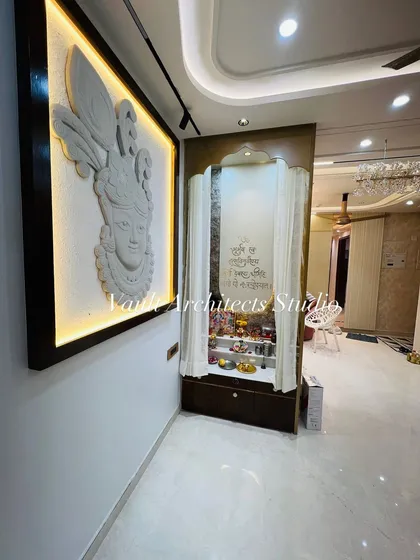 We believe every home needs a peaceful corner. This custom pooja space combines a traditional mandir with a stunning, back-lit Krishna stone mural, creating a focal point for devotion and tranquility.
