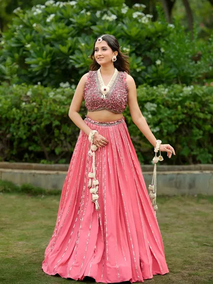 The floral hathphool and kalire add a graceful touch to her Haldi ensemble. All pieces are handcrafted to perfection.