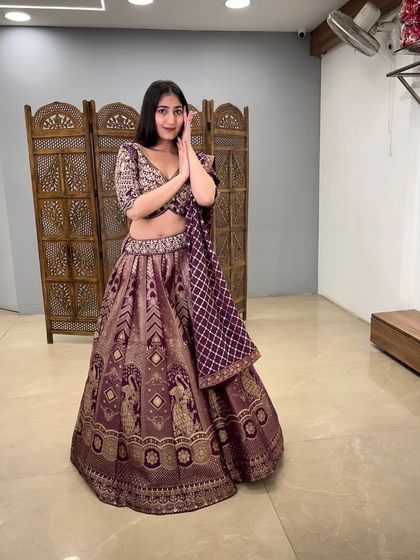 A playful and happy shot in the purple lehenga, perfect for a wedding guest who loves traditional textiles.