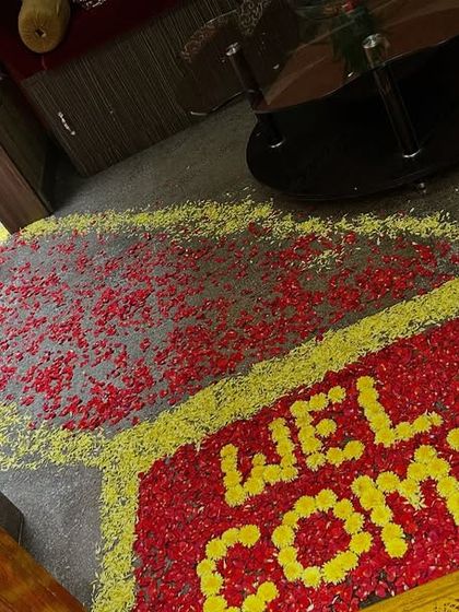 Another angle of the flower petal rangoli, a beautiful detail for a wedding or housewarming ceremony entrance.
